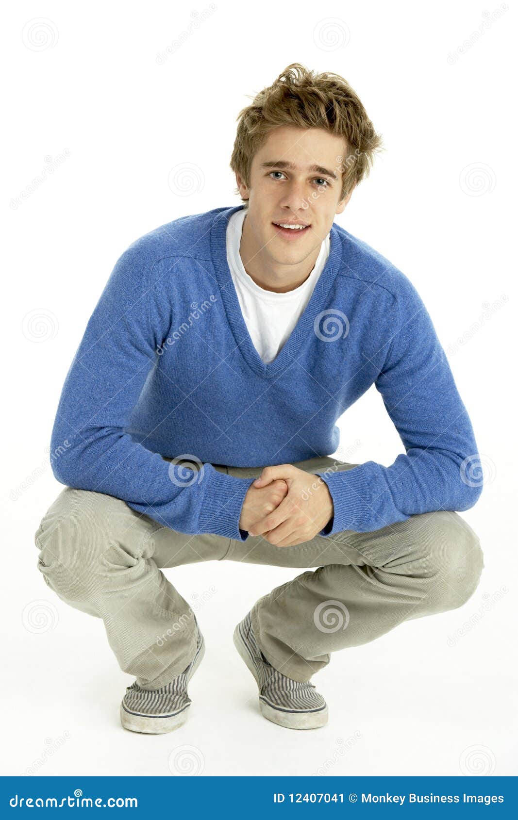 young man crouching in studio