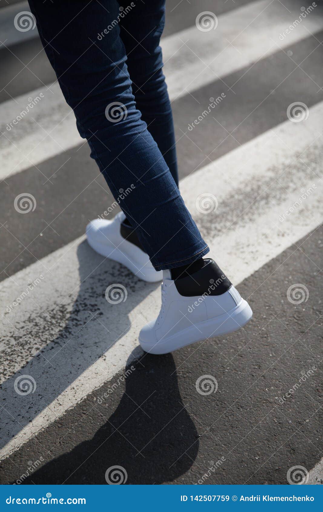 Young Man in a Dark Trousers and Sneakers Crossing the Road Stock Image ...