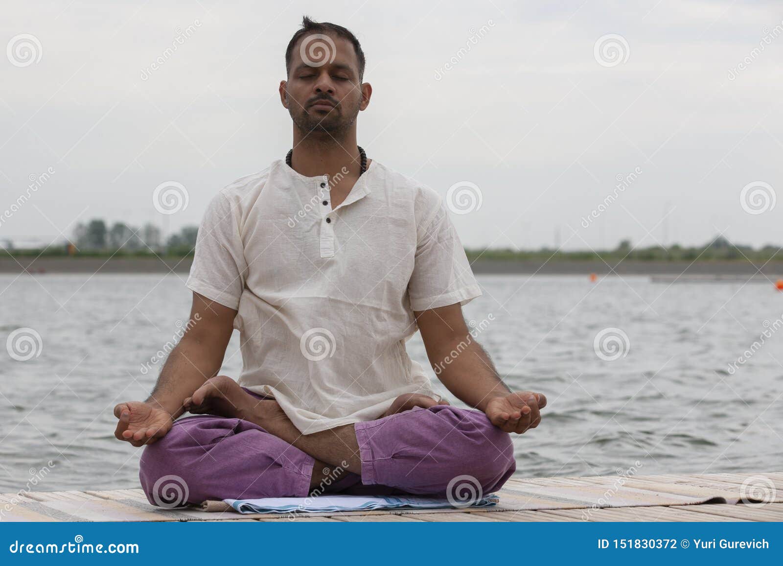 Young Man Doing Yoga and Meditating in Warrior Pose on Beach Stock ...