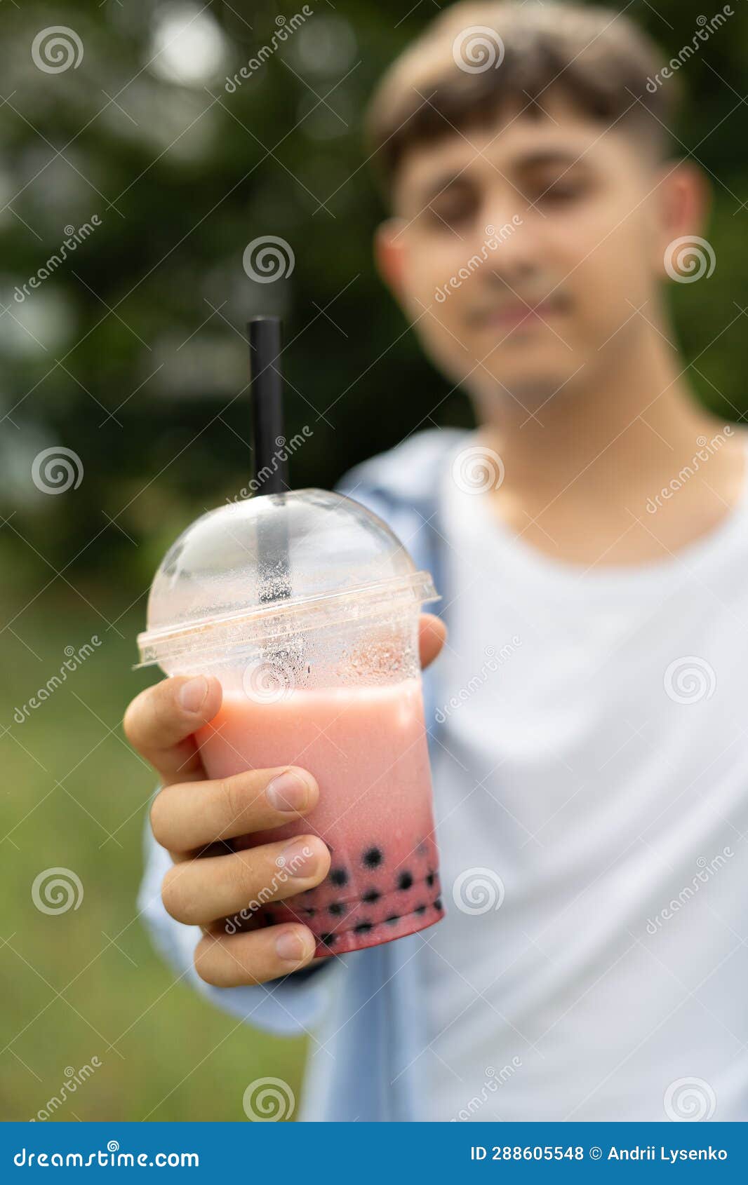 Young Man Drinking Bubble Tea and Enjoy Summer Vacation Showing Plastic