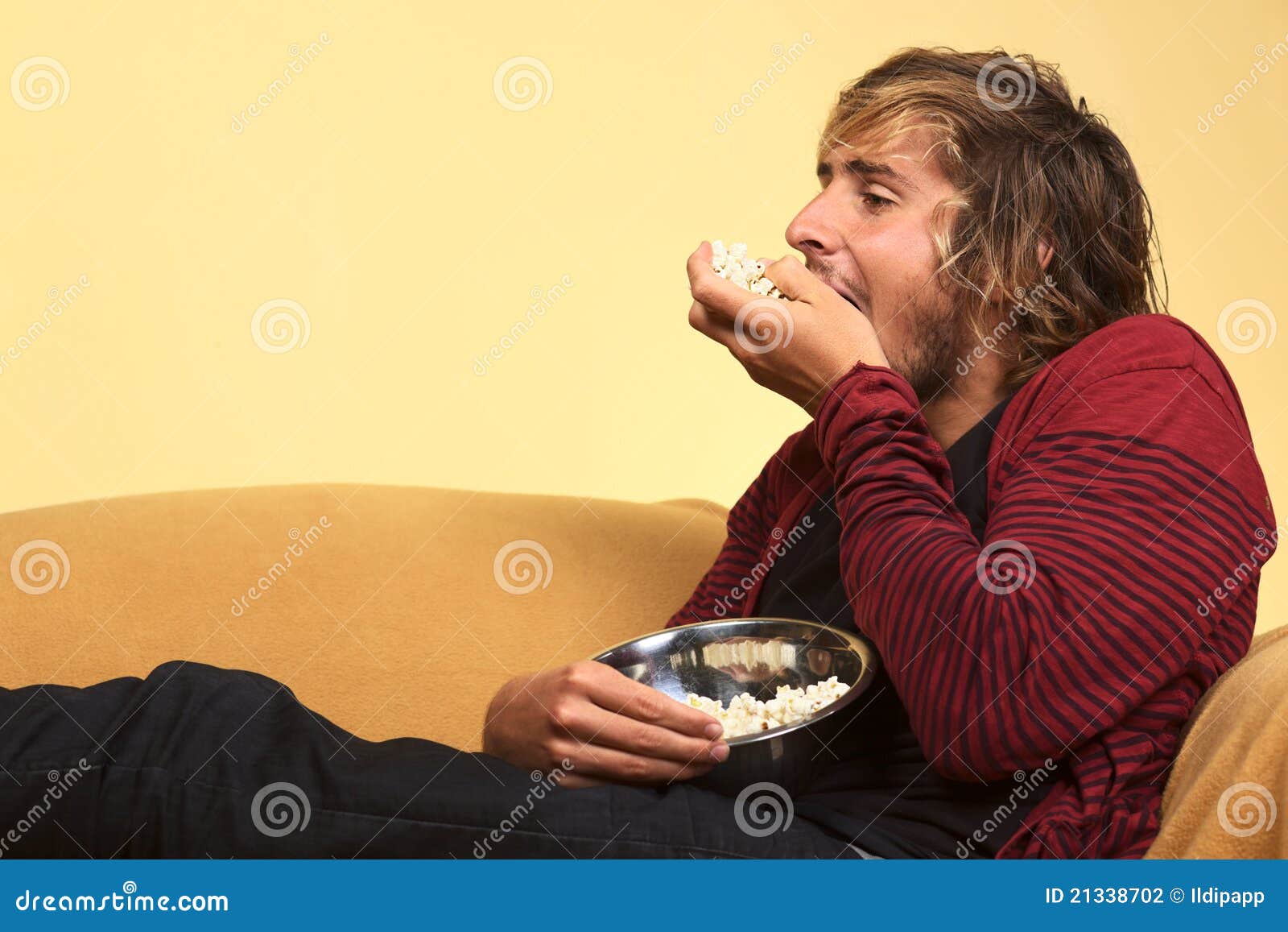 Young Man Eating Popcorn stock photo. Image of holding 21338702