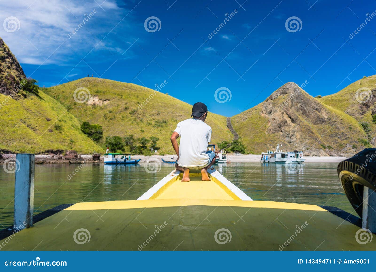 young man enjoying the tranquil view of padar island during summer vacation