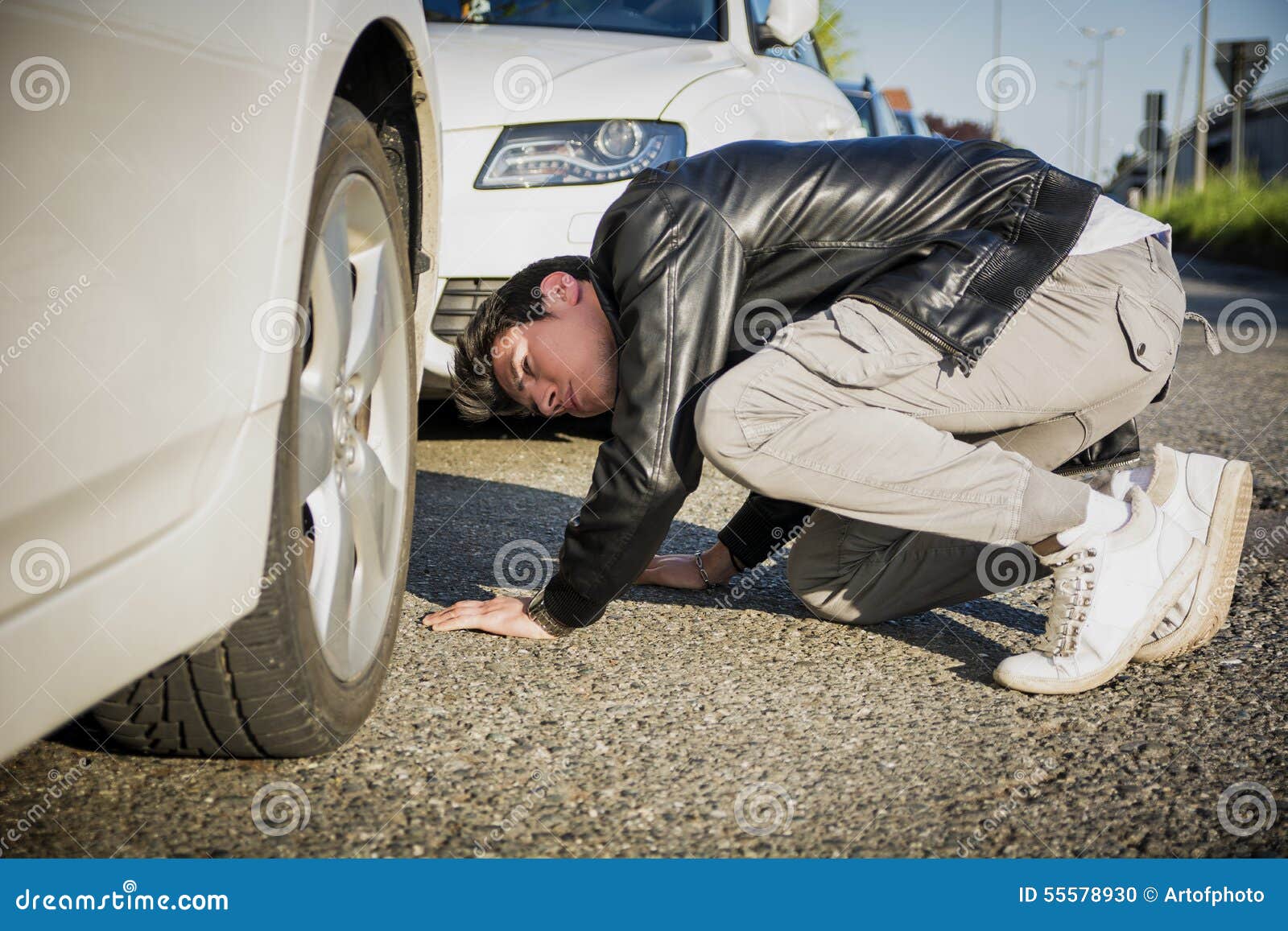 Young Man Examining Underside of Car Stock Photo Image of adult