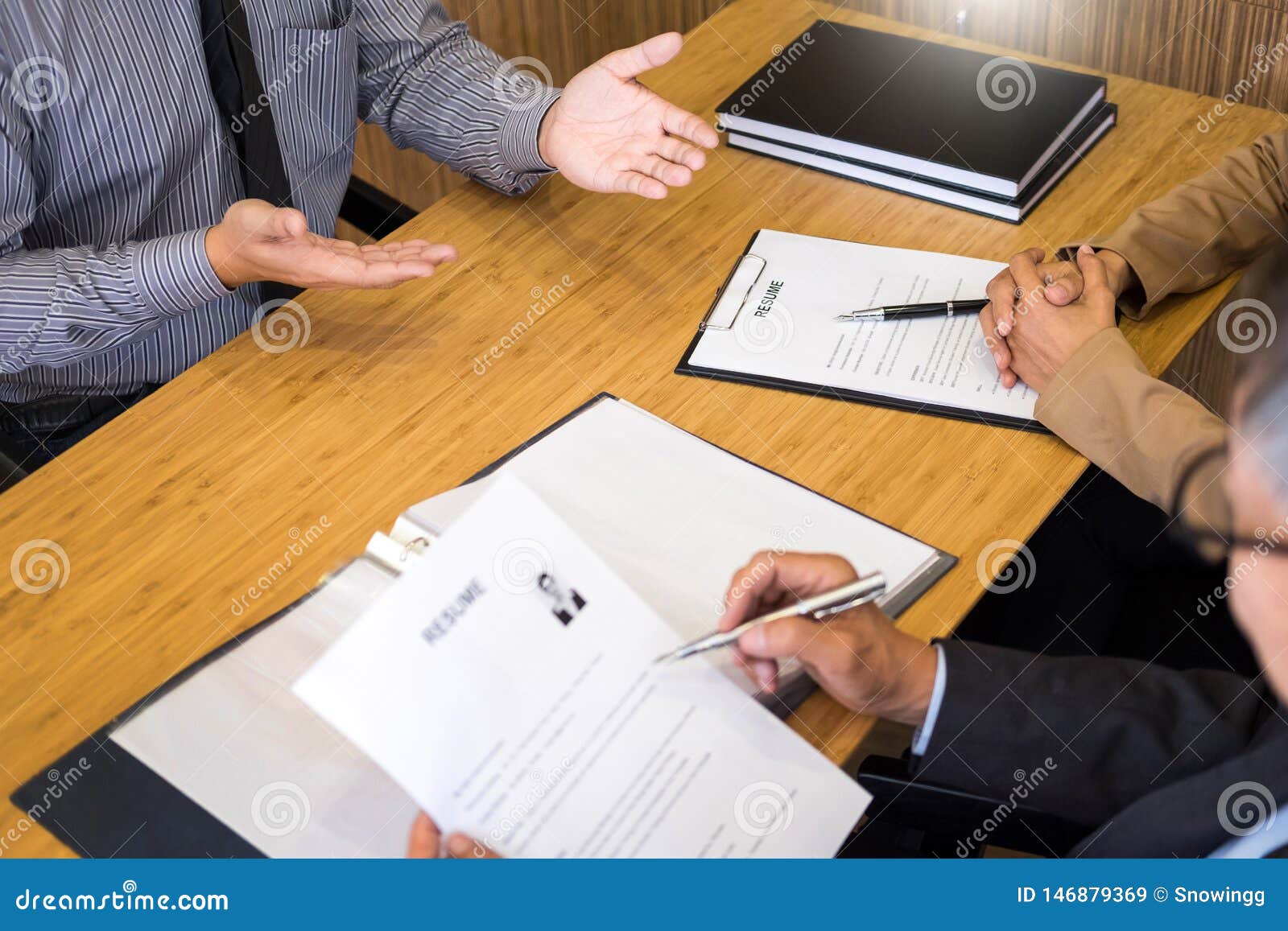 Young Man Explaining About His Profile To Business Managers