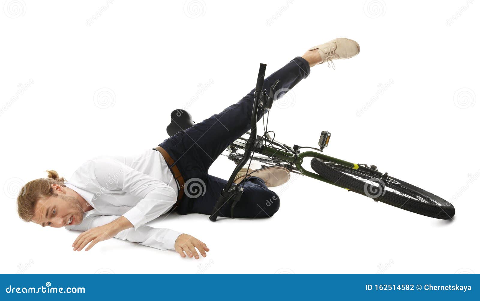 Young Man Falling Off Bicycle On Background Stock Photo