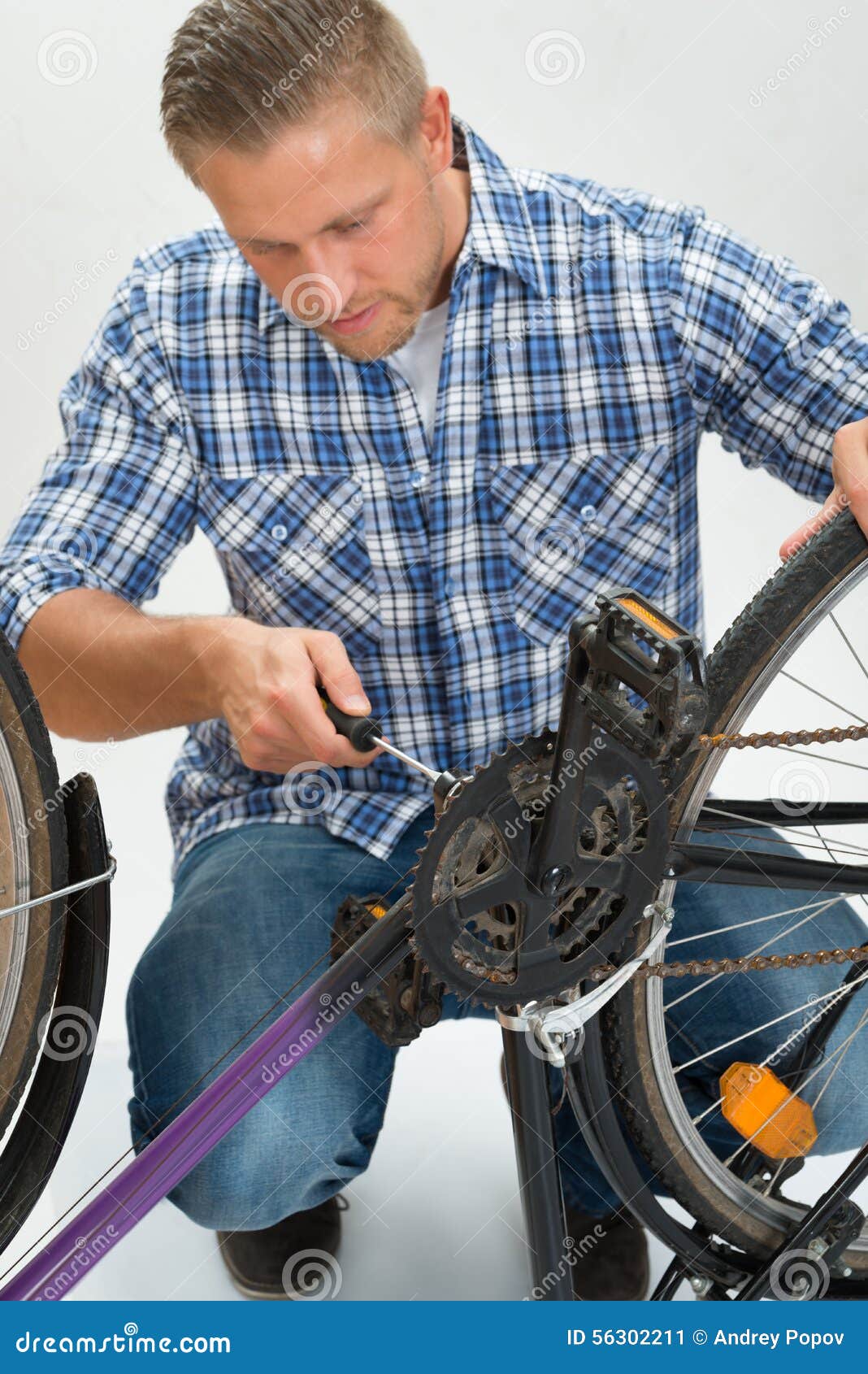 Young Man Fixing Bicycle stock image. Image of adult 56302211