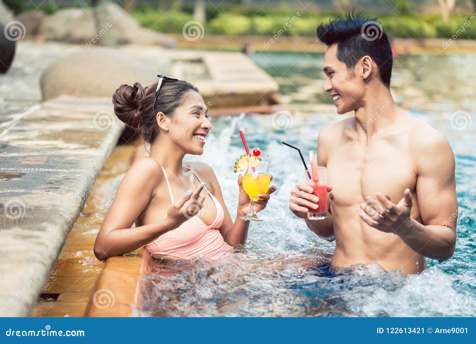 Young Man Flirting with an Attractive Woman in a Trendy Swimming Pool Stock Image