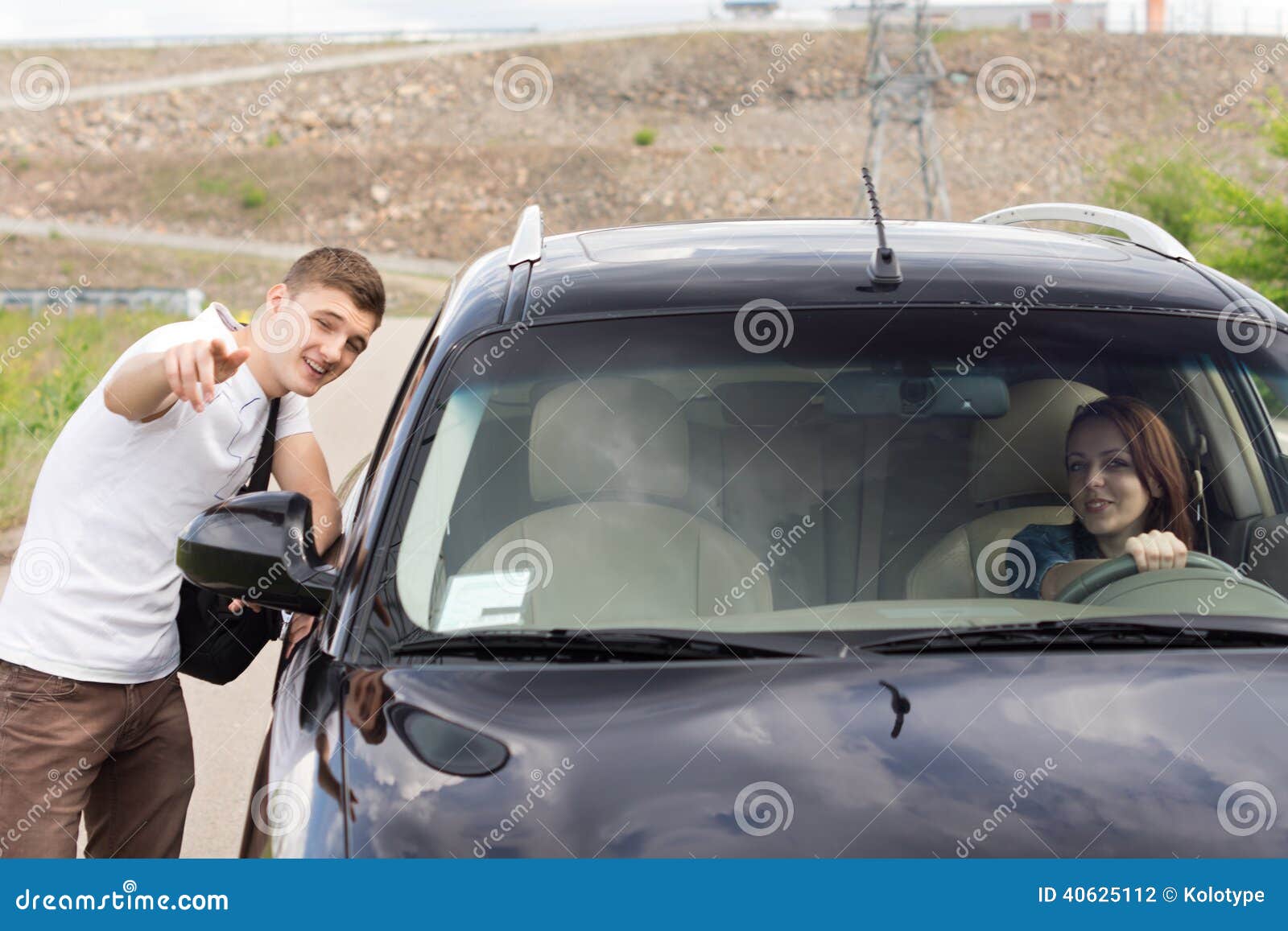 young man giving directions to a woman driver