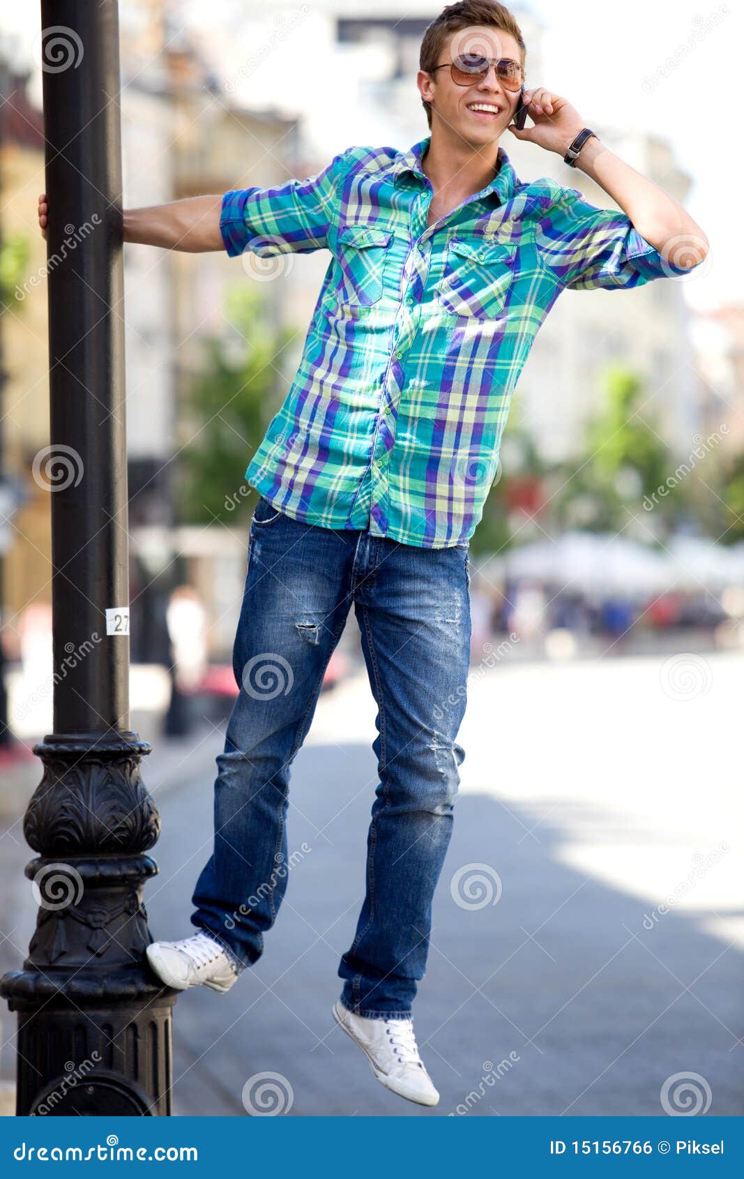 Young Man Hanging On Lamp Post Stock Photo - Image of lantern, lamp