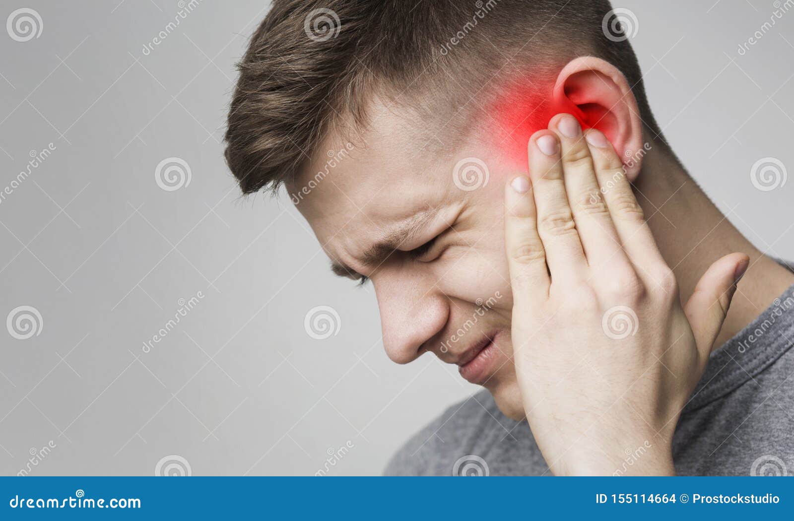 young man has sore ear, suffering from otitis