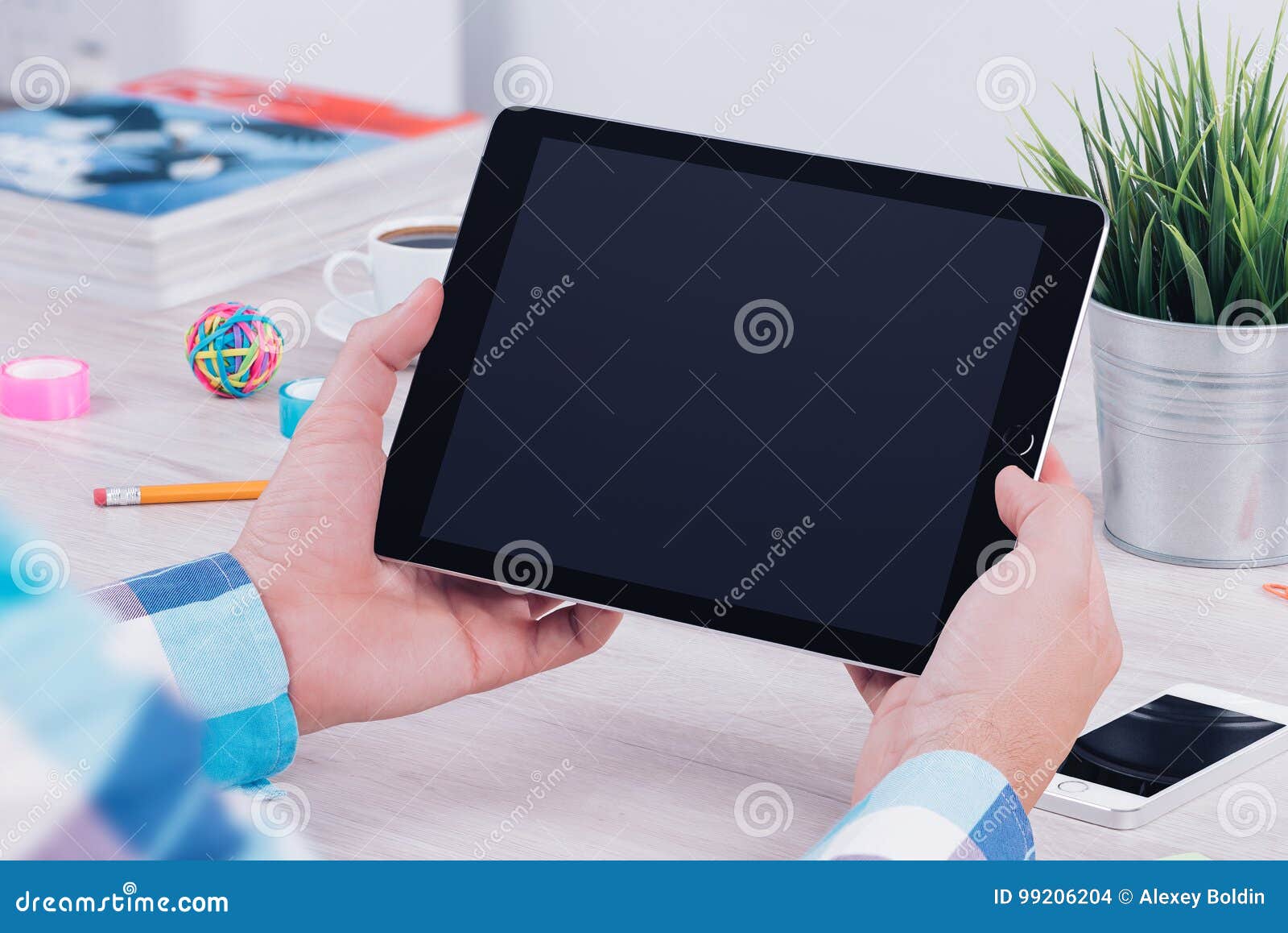 young man holding ipad digital tablet on table desk