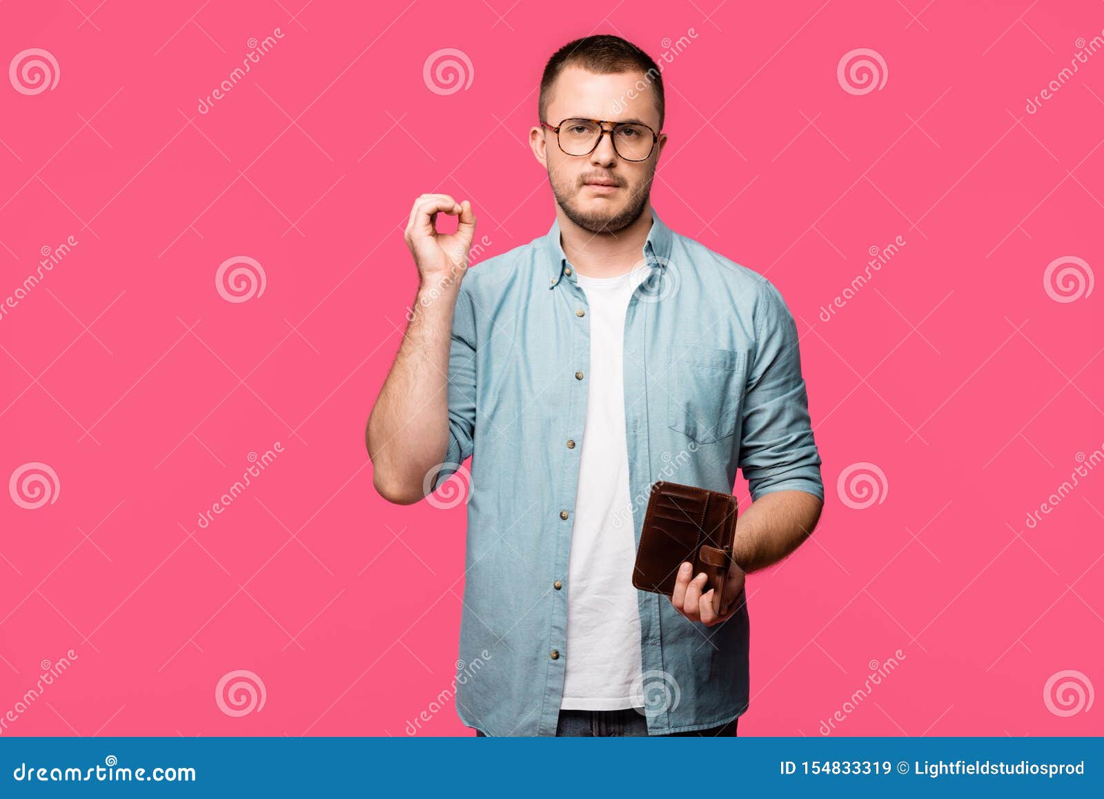 Young Man Holding Empty Wallet and Showing Zero Sign Isolated Stock