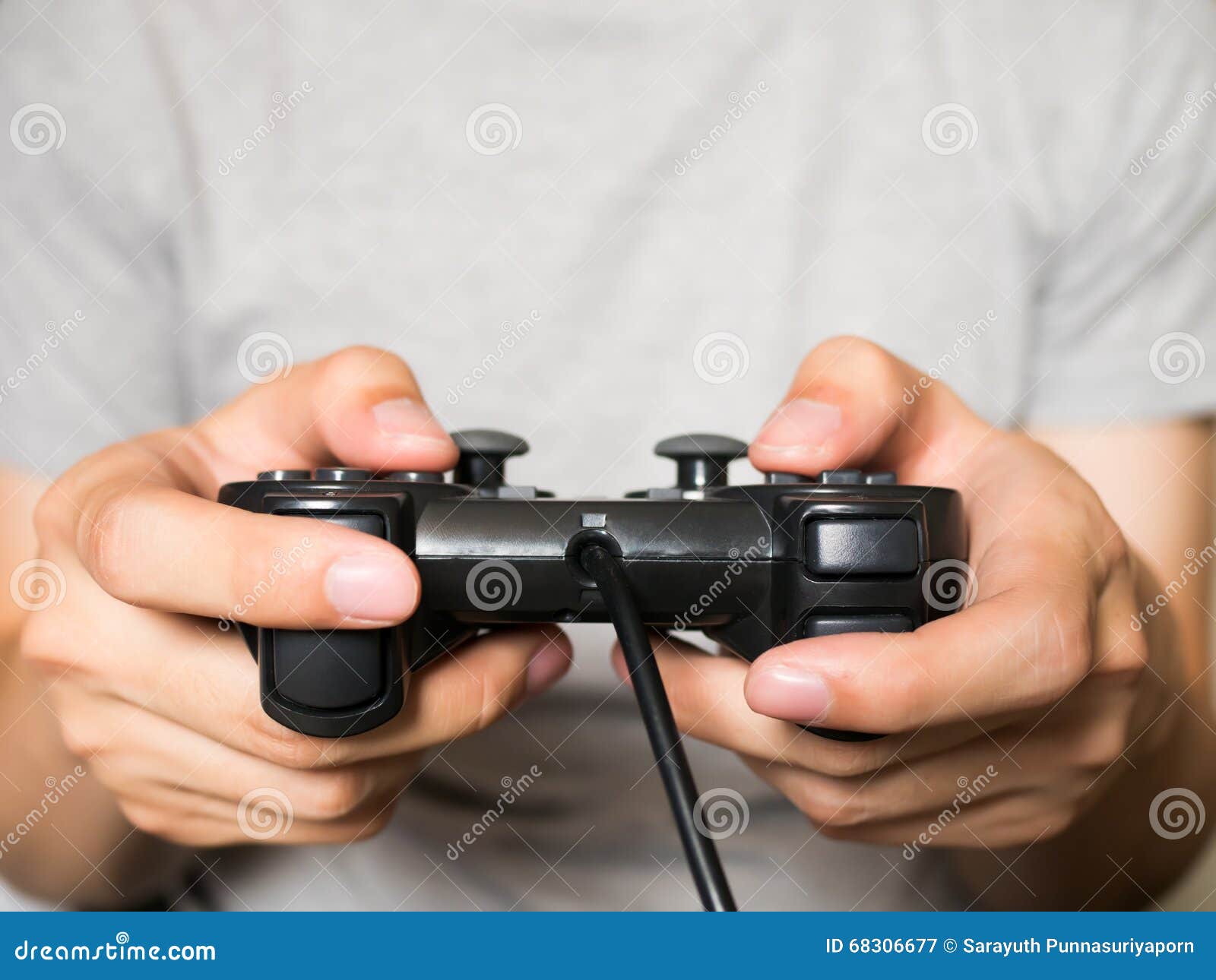 Premium Photo  Close up of gamer holding controller to play video games in  front of computer. player using joystick and playing online games on  monitor, sitting at desk. man gaming with