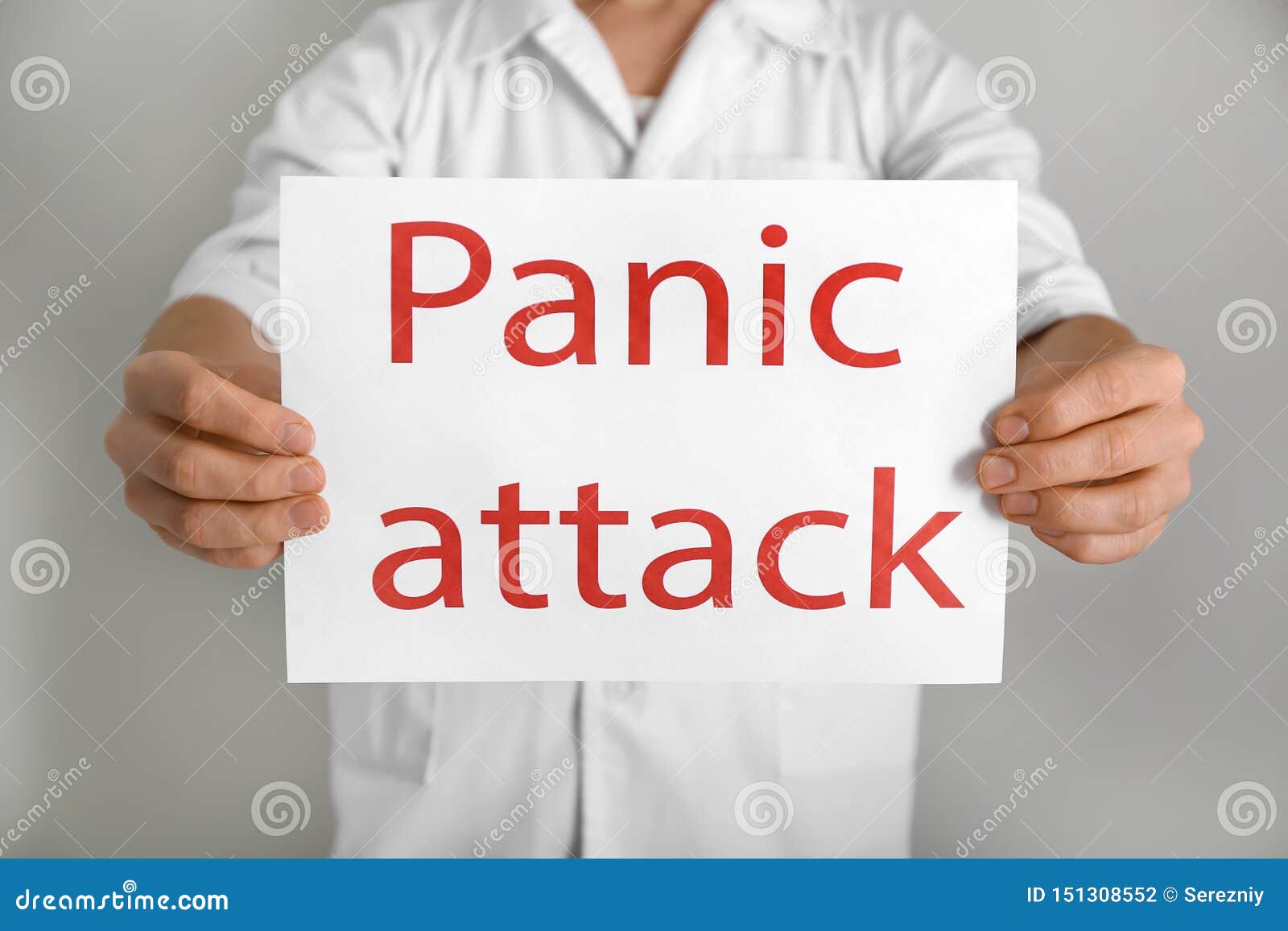 Young Man Holding Sheet Of Paper With Words PANIC ATTACK On Light