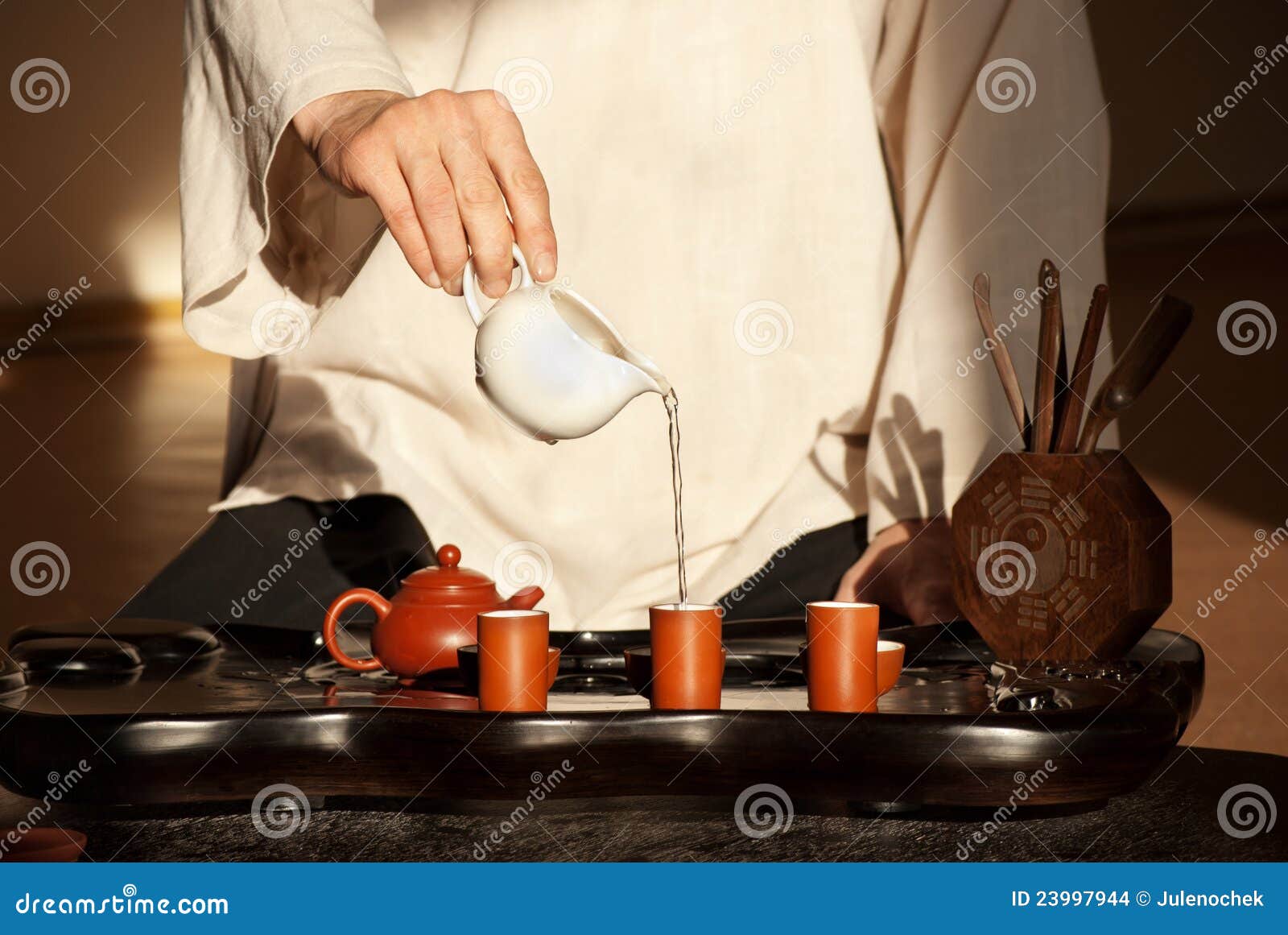 a young man holds a chinese tea ceremony