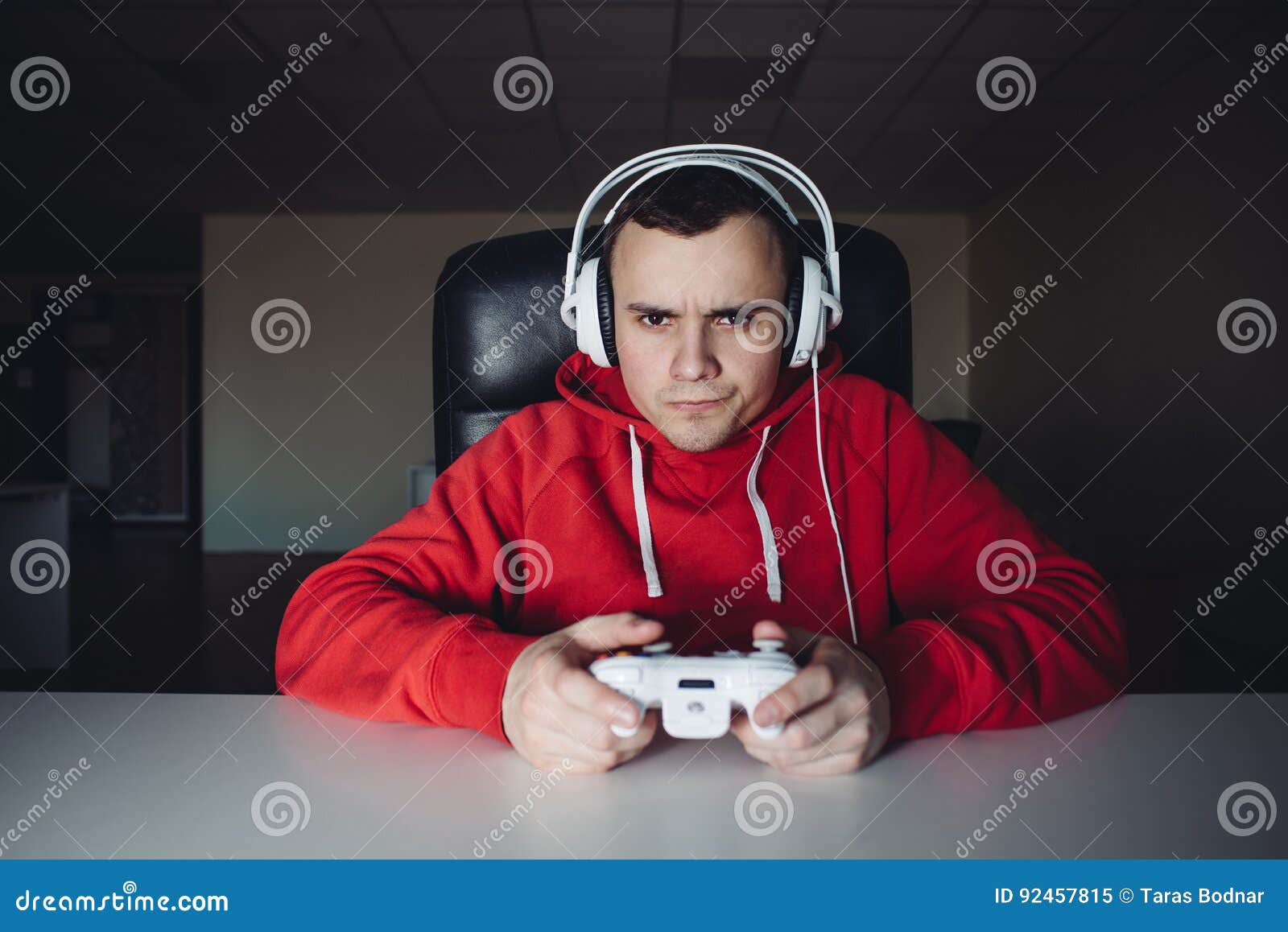 Person playing video games with controller on computer Stock Photo