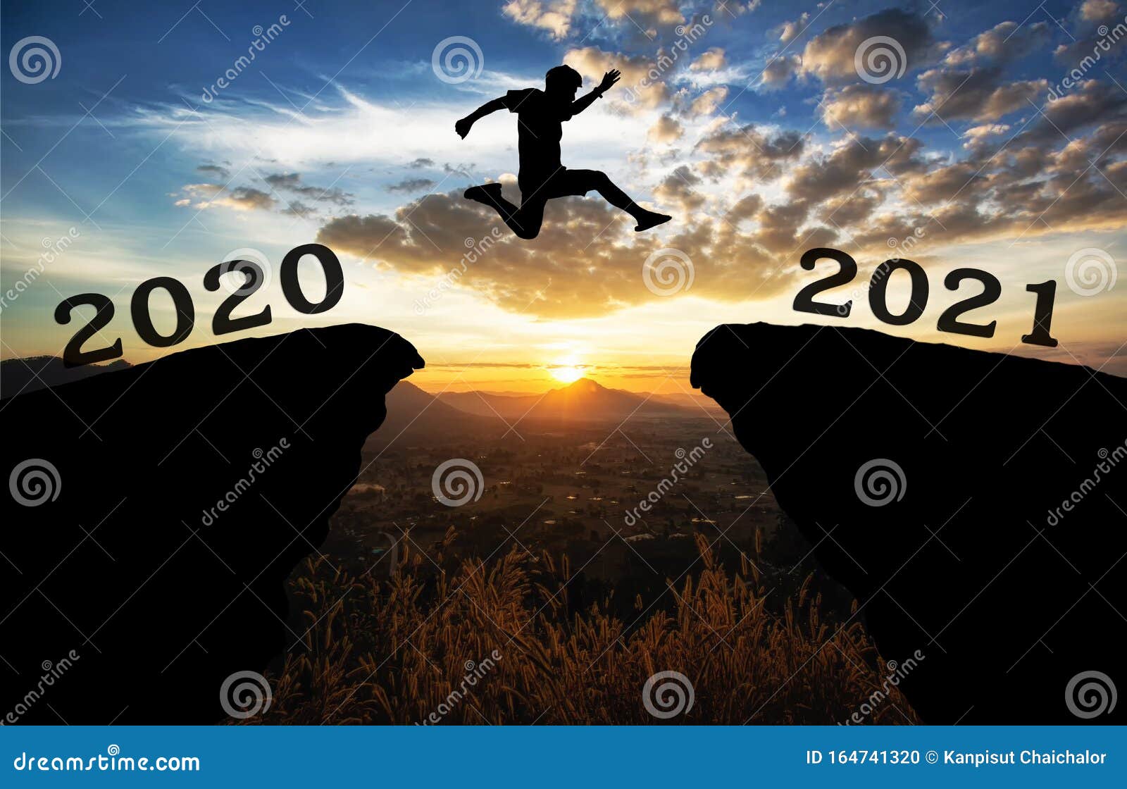 A Young Man Jump between 2020 and 2021 Years Over the Sun and through on the Gap of Hill