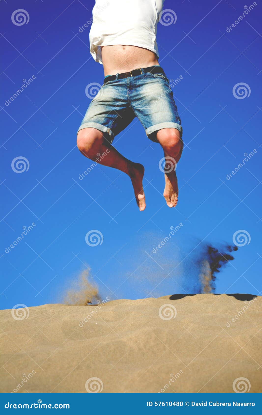 Young Man Jumping on a Dune Stock Photo Image of excited, desert 57610480