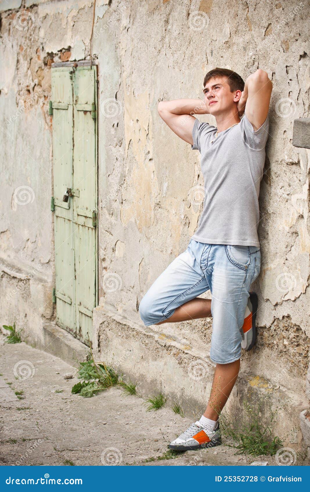 Young Man Leaning on a Grunge Wall Stock Photo Image of lean Young Man Leaning on a Grunge Wall Stock Photo Image of lean