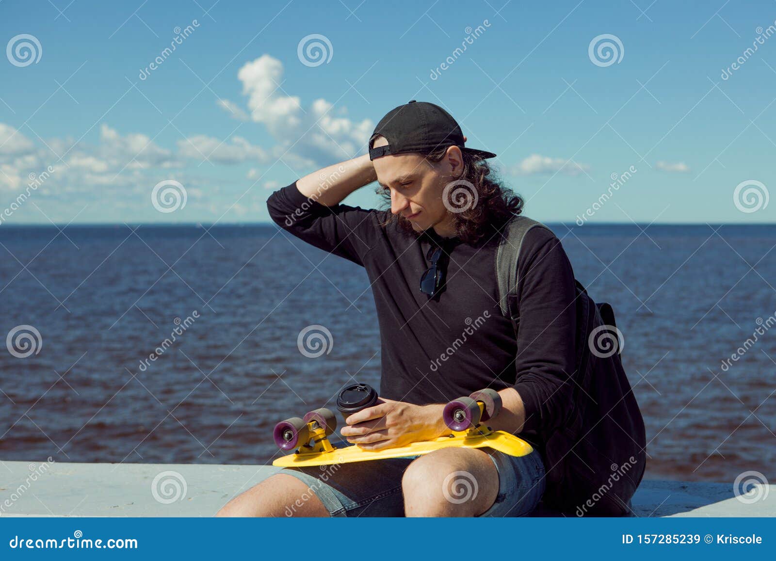 A Young Man with Long Hair a Taking a Rest Sitting with a Yellow Skate and the Coffee on the City`s Quay. Stock Image - Image of embankment, asphalt: 157285239 A Young Man with Long Hair a Taking a Rest Sitting with a Yellow Skate and the Coffee on the City`s Quay. Stock Image - Image of embankment, asphalt: 157285239