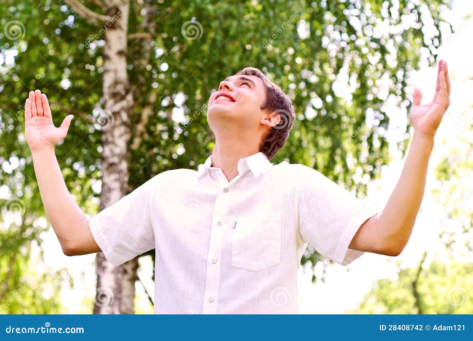 Young Man Looking To the Sky, Holding His Hands Up Stock Photo Image