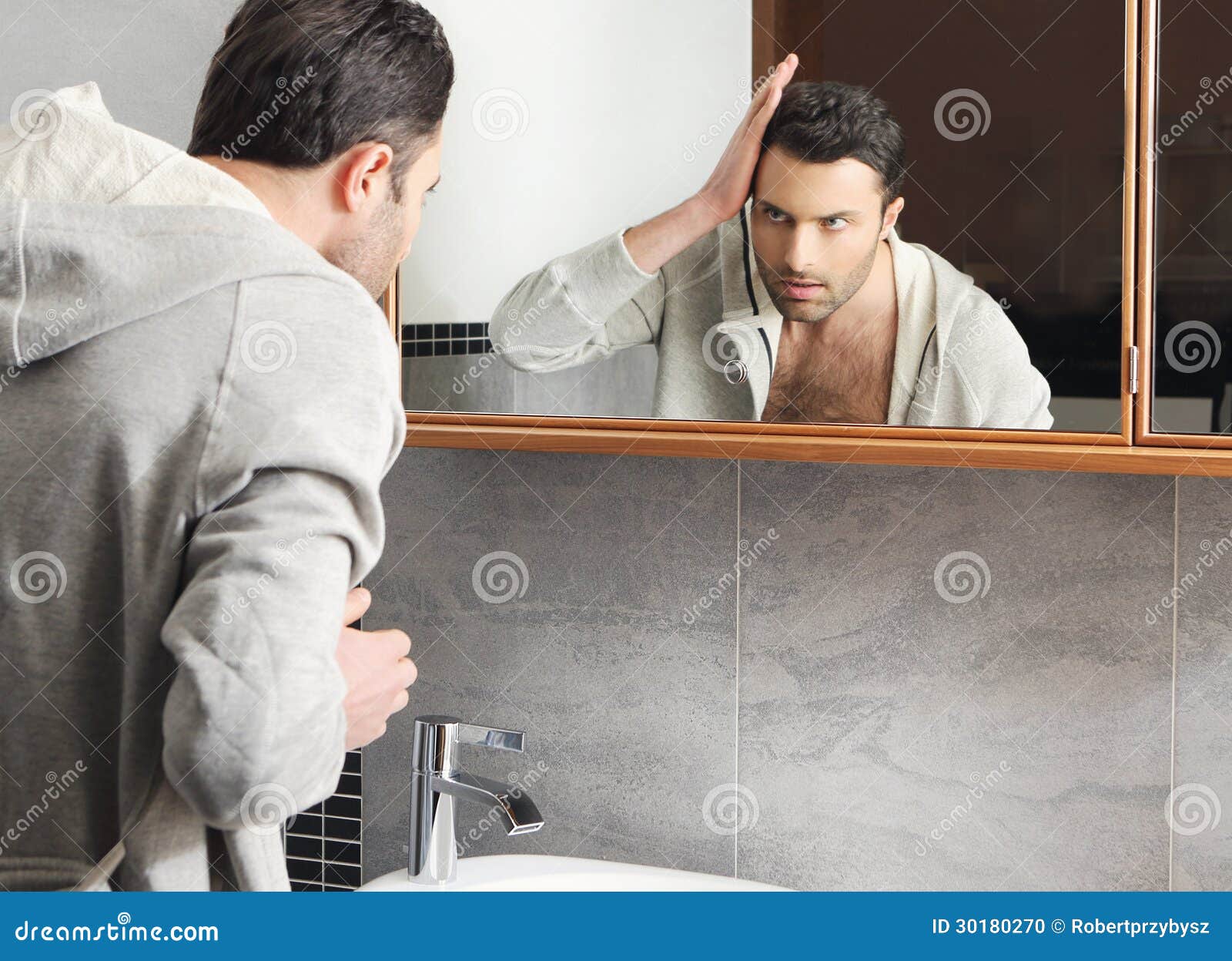 Man Looks At Himself In The Mirror Stock Photo - Image 