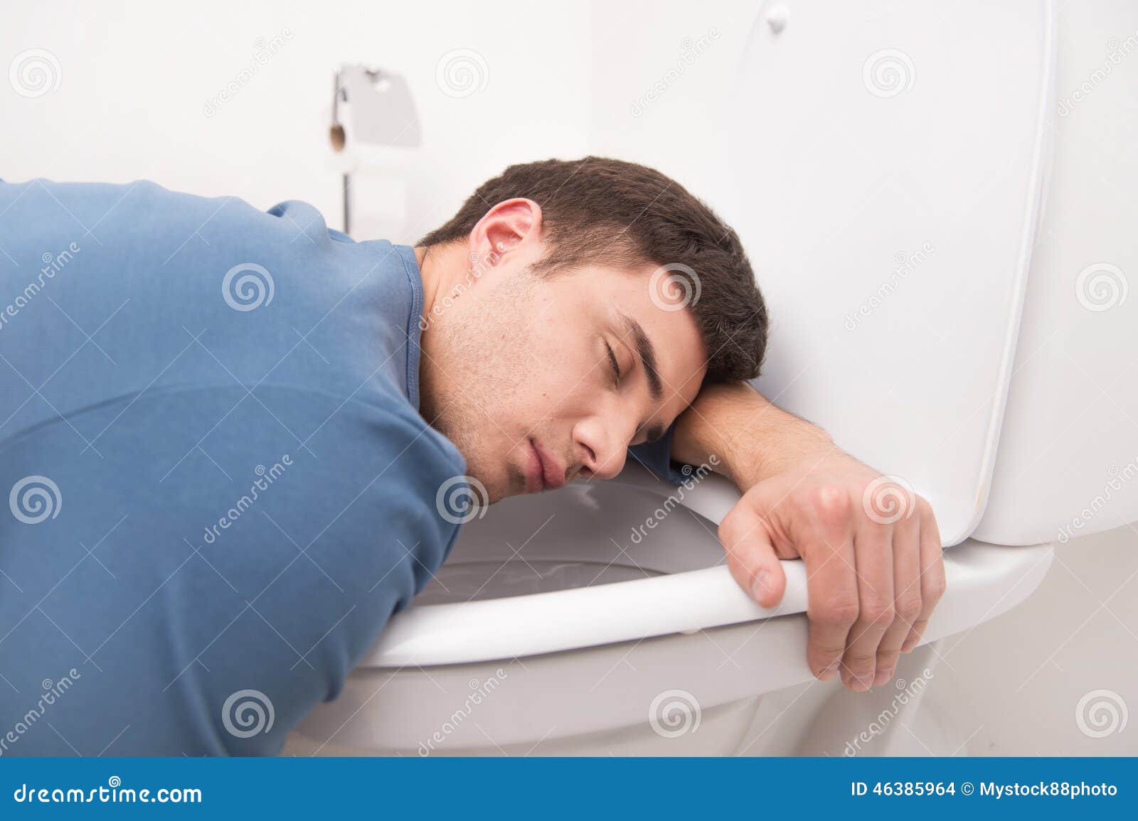 Young Man Lying on Toilet Seat. Stock Photo Image of crushed, awful