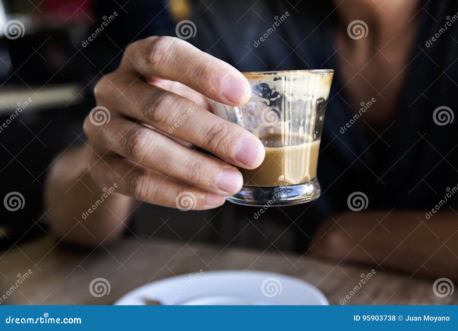 young man with a macchiato in a coffeehouse