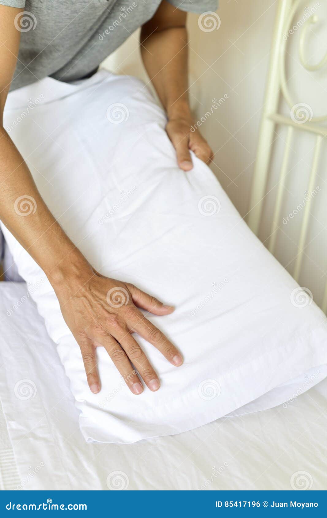 Young man making the bed stock photo. Image of making 85417196