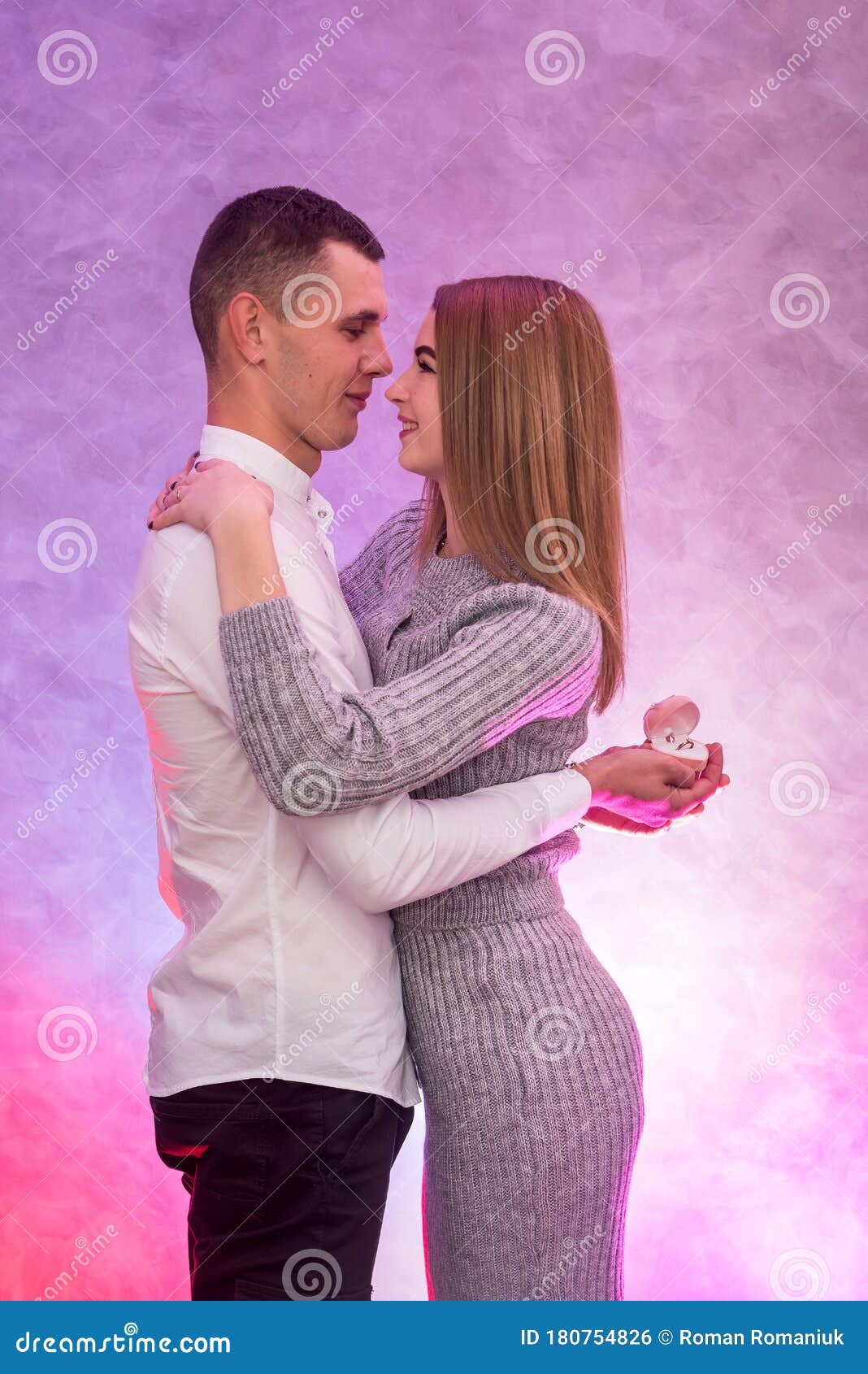 Young Man Making Proposal with Gold Ring with Diamond To His Girl