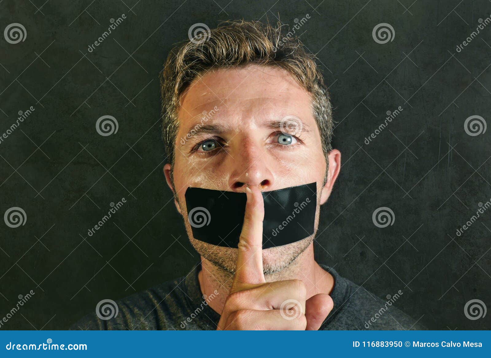 young man with mouth and lips sealed covered with adhesive tape in censorship coerced freedom of speech and forced silence and sec
