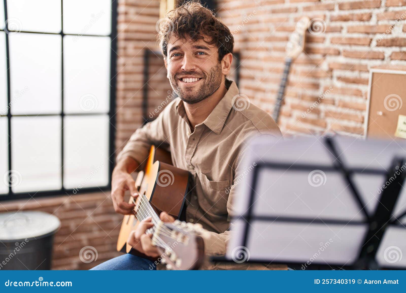 Young Man Musician Smiling Confident Playing Classical Guitar at Music