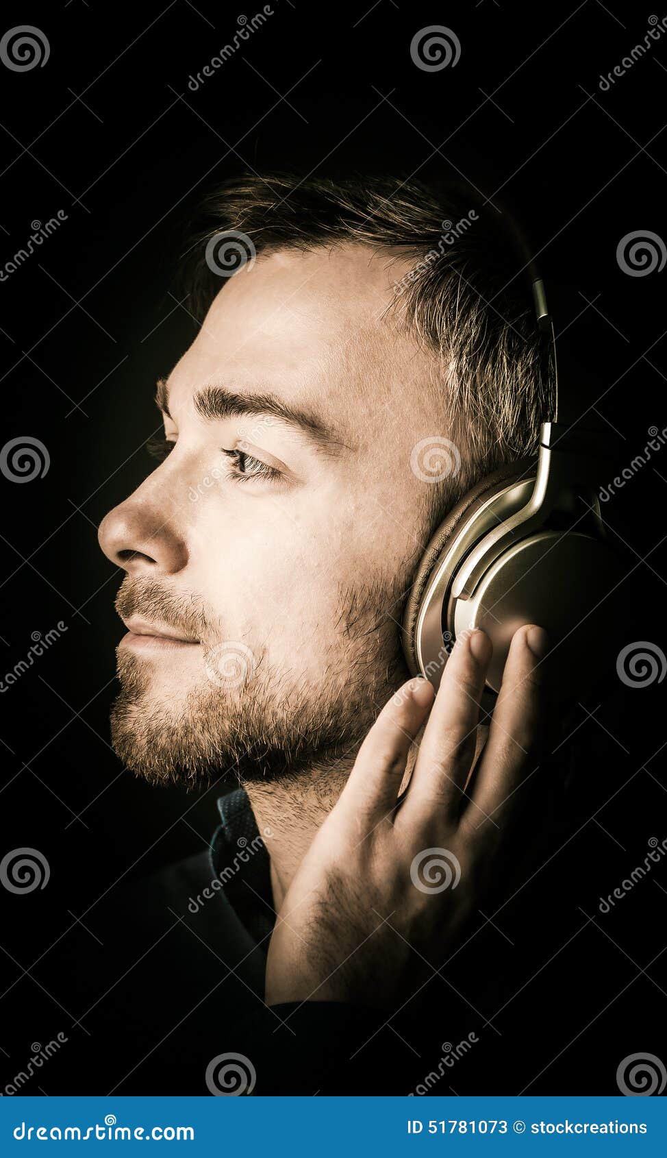 young man musing as he listens to music