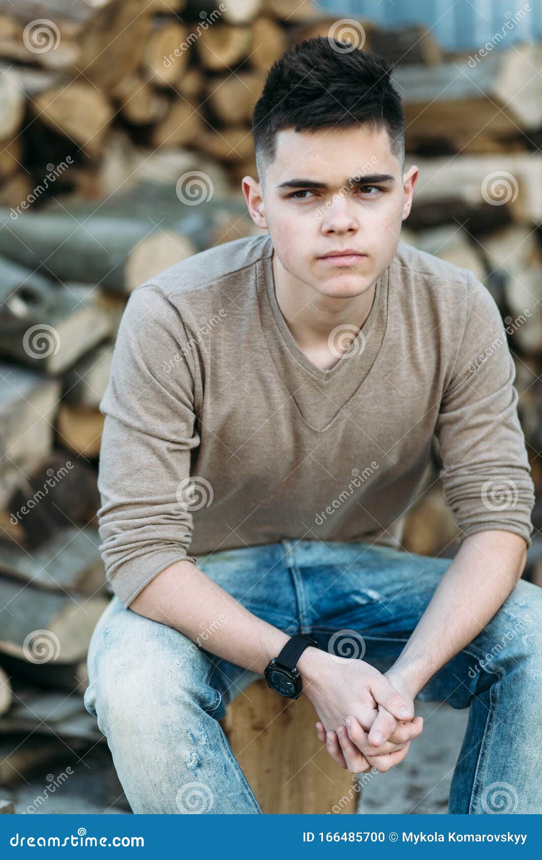 Young man near firewood stock photo. Image of casual - 166485700