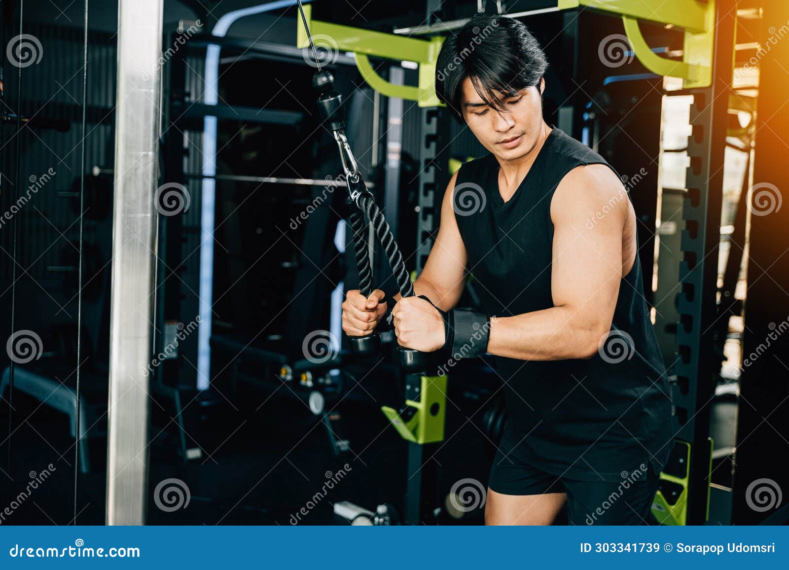 Young Man Performing Cable Triceps Pulldowns To Build Muscle and
