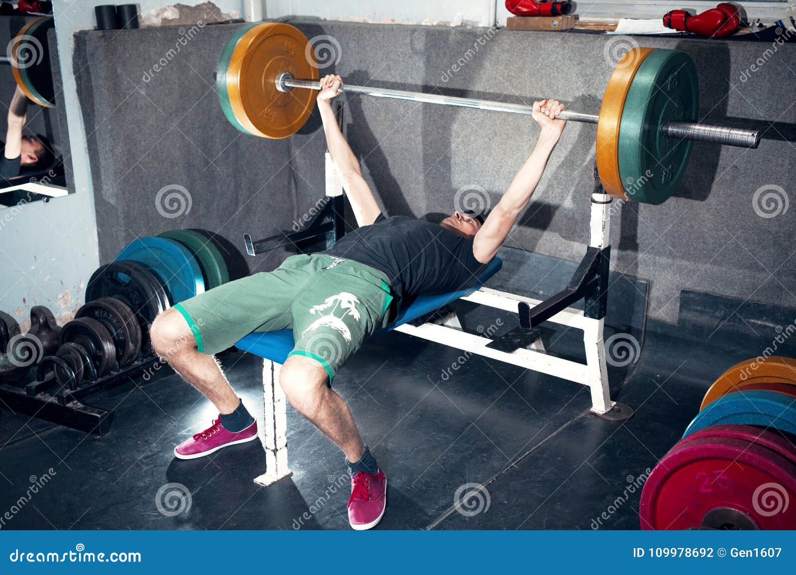 A Young Man Performs Bench Press With A Barbell Stock Photo