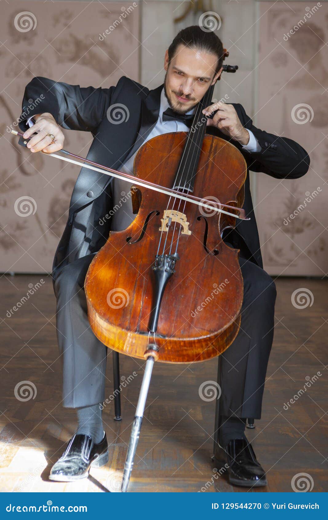 Young Man Playing The Cello. Portrait Of The Cellist Stock Photo