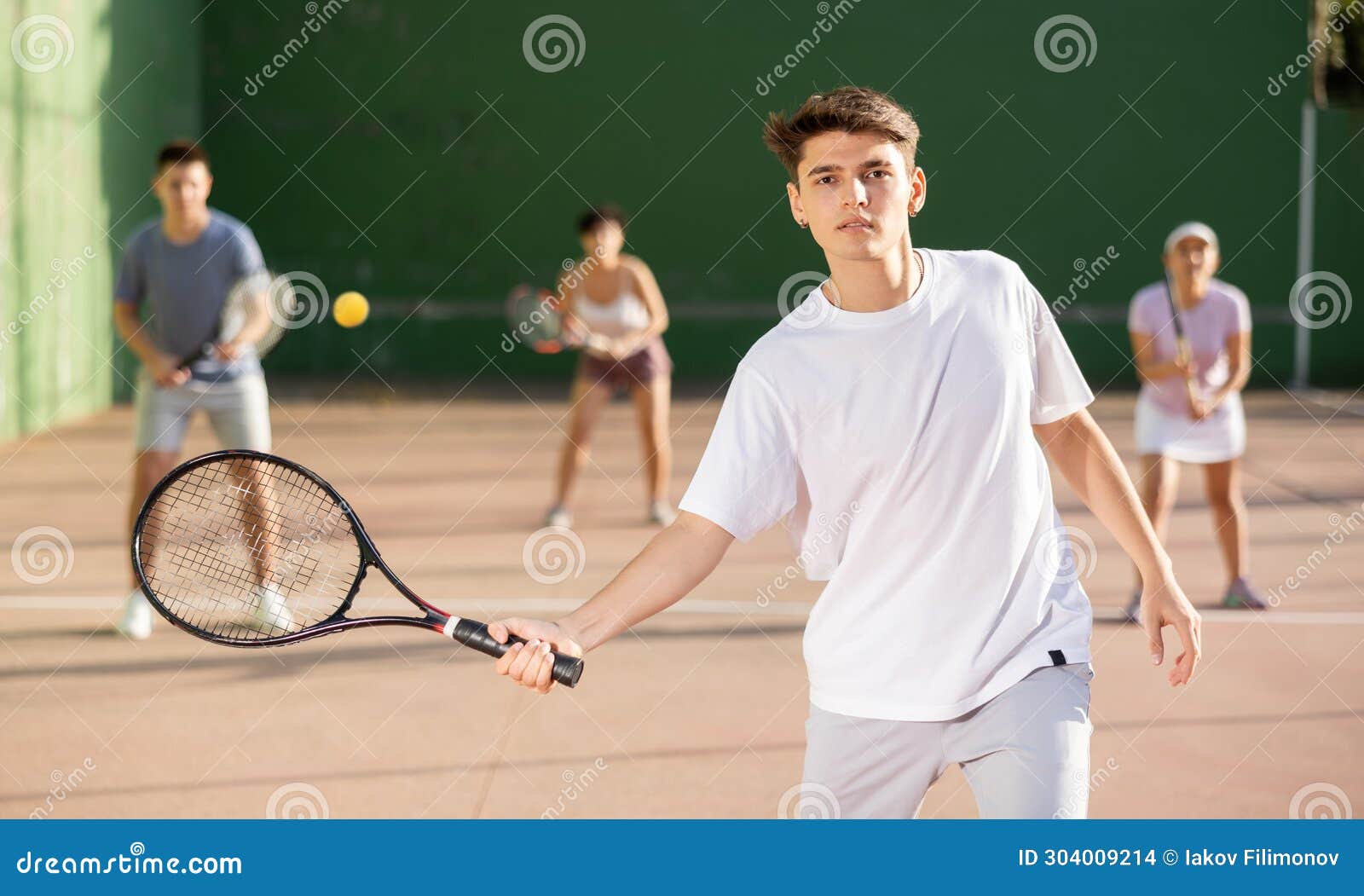 young man playing frontenis on outdoor pelota court