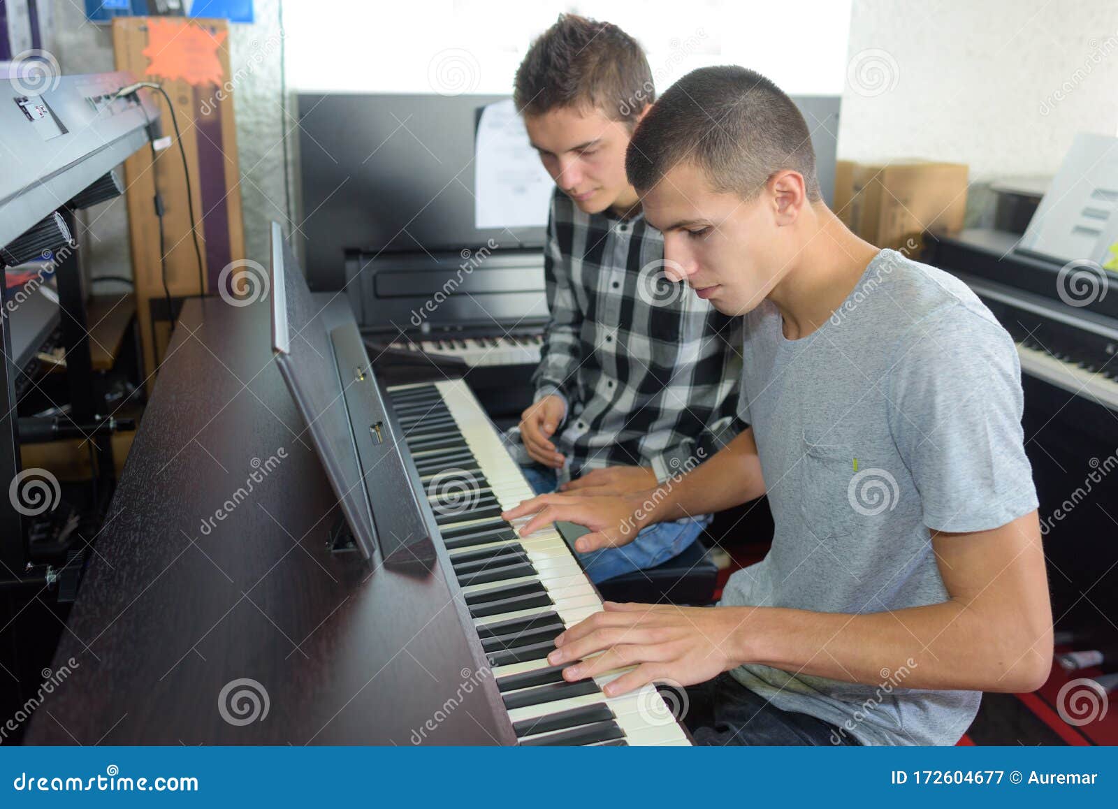 Young man playing keyboard stock image. Image of pianist 172604677