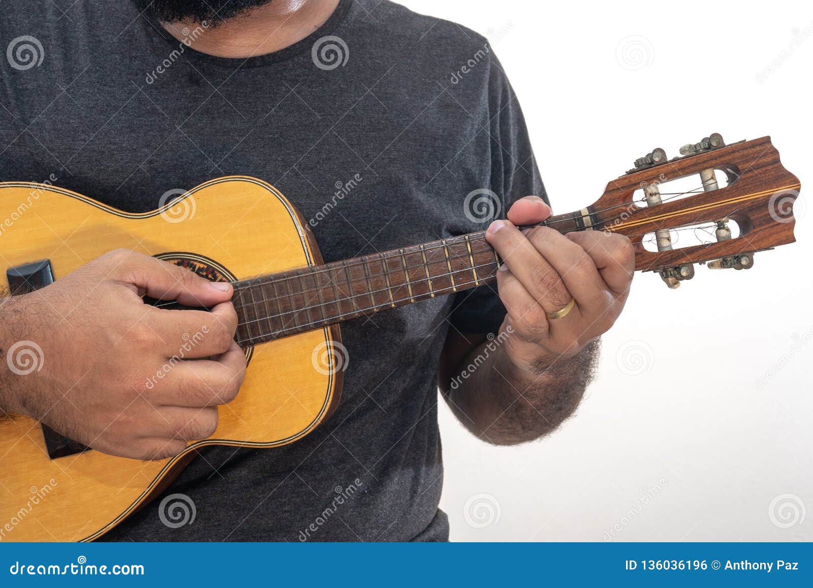 young man playing ukulele with shirt and black pants