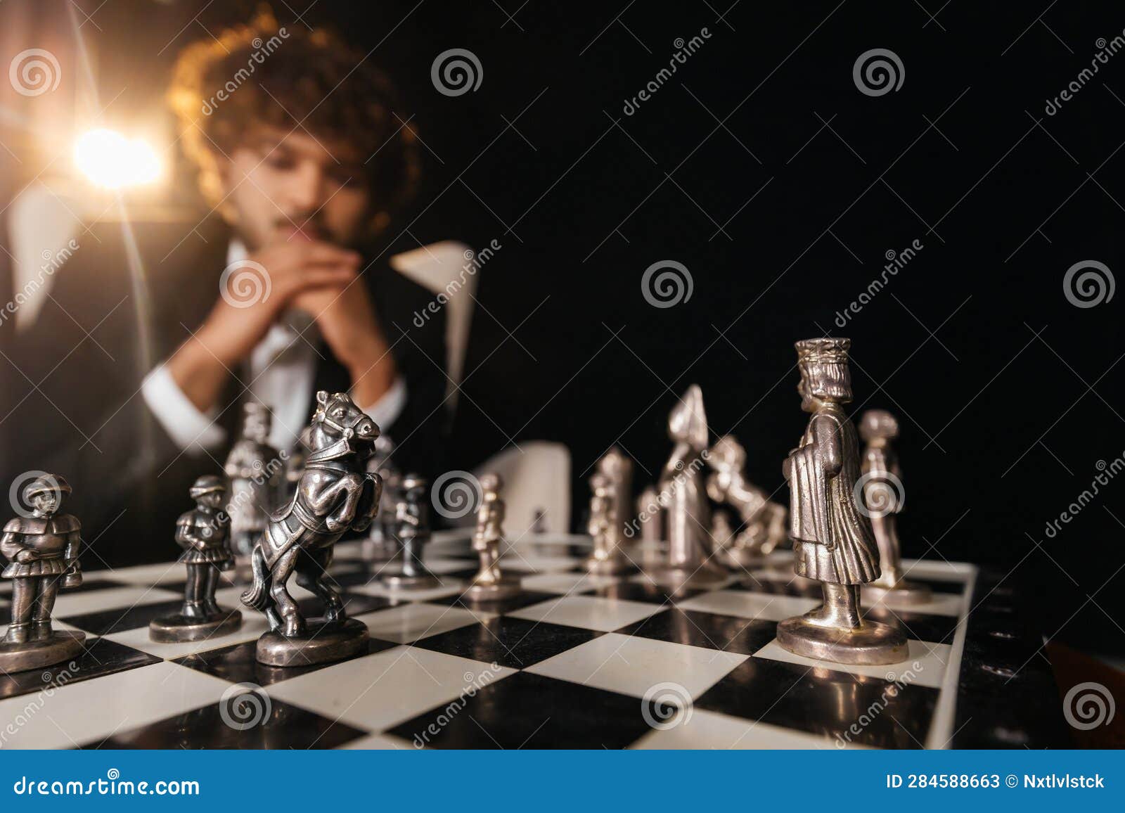 Handsome Male Model Considers His Next Chess Move Stock Photo