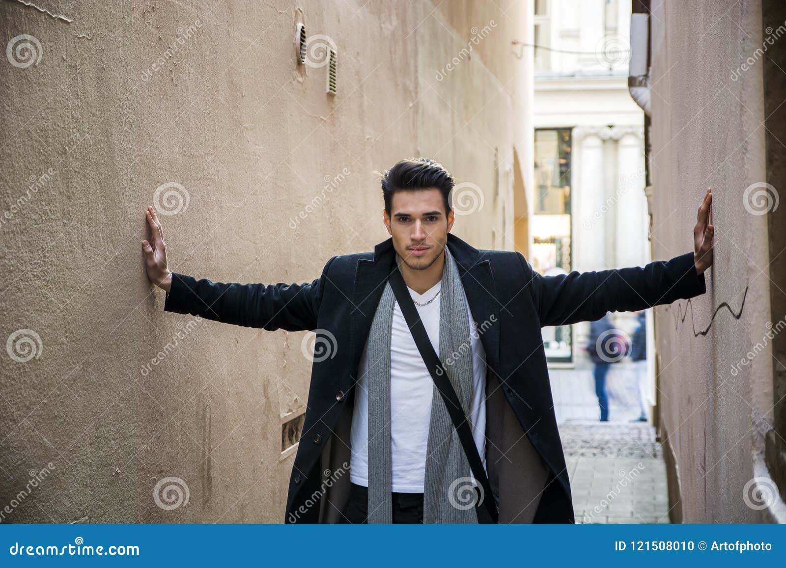 young man pressed between two walls. oppression, anxiety