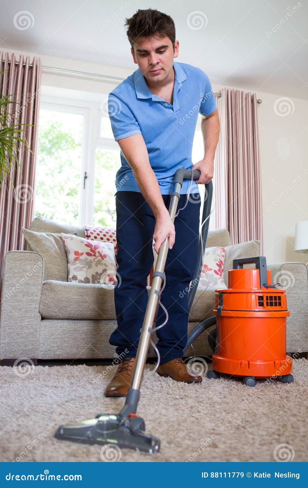 young man professionally cleaning carpets