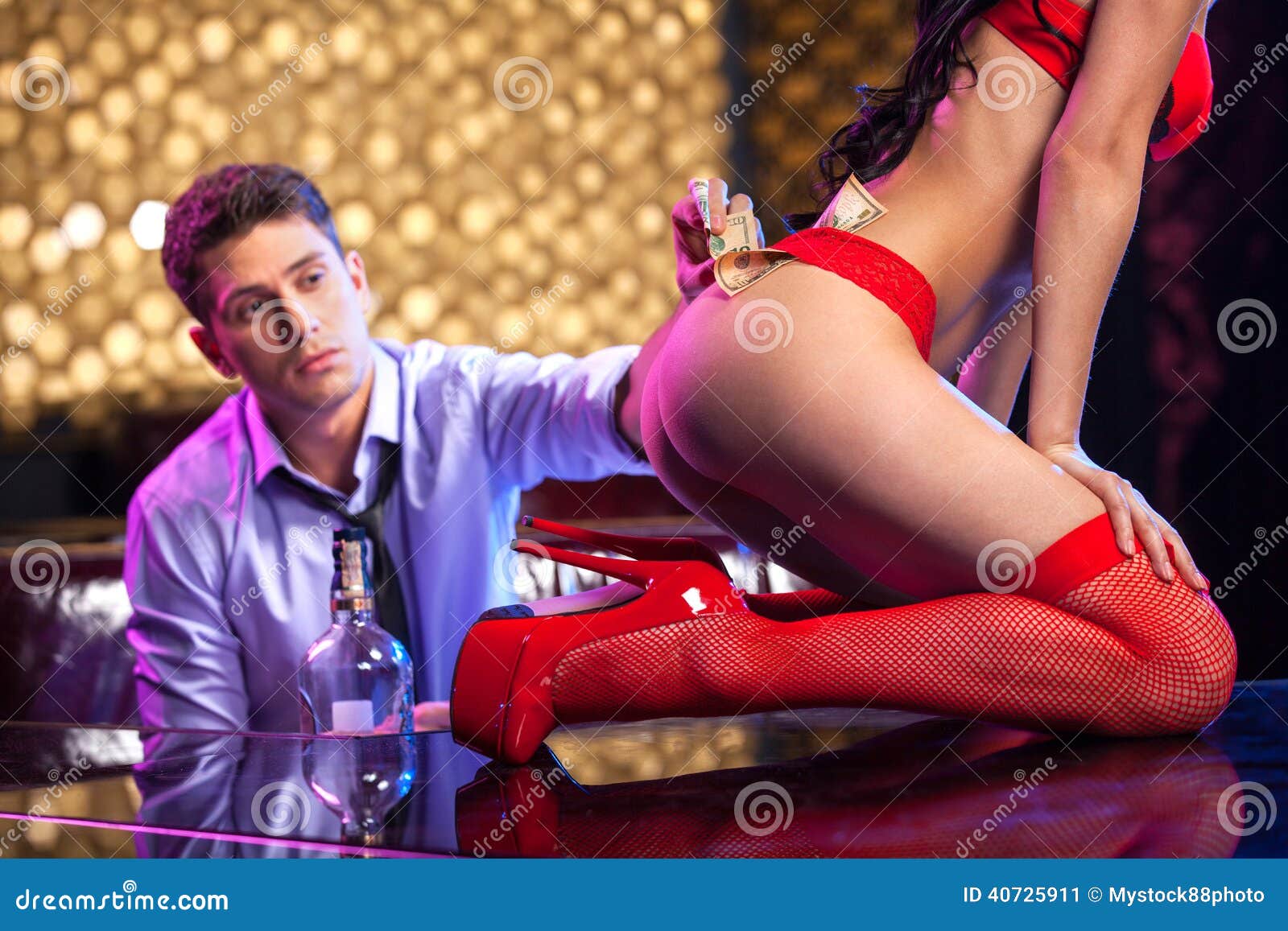 Young Man Putting Dollars in Striptease Dancer Panties