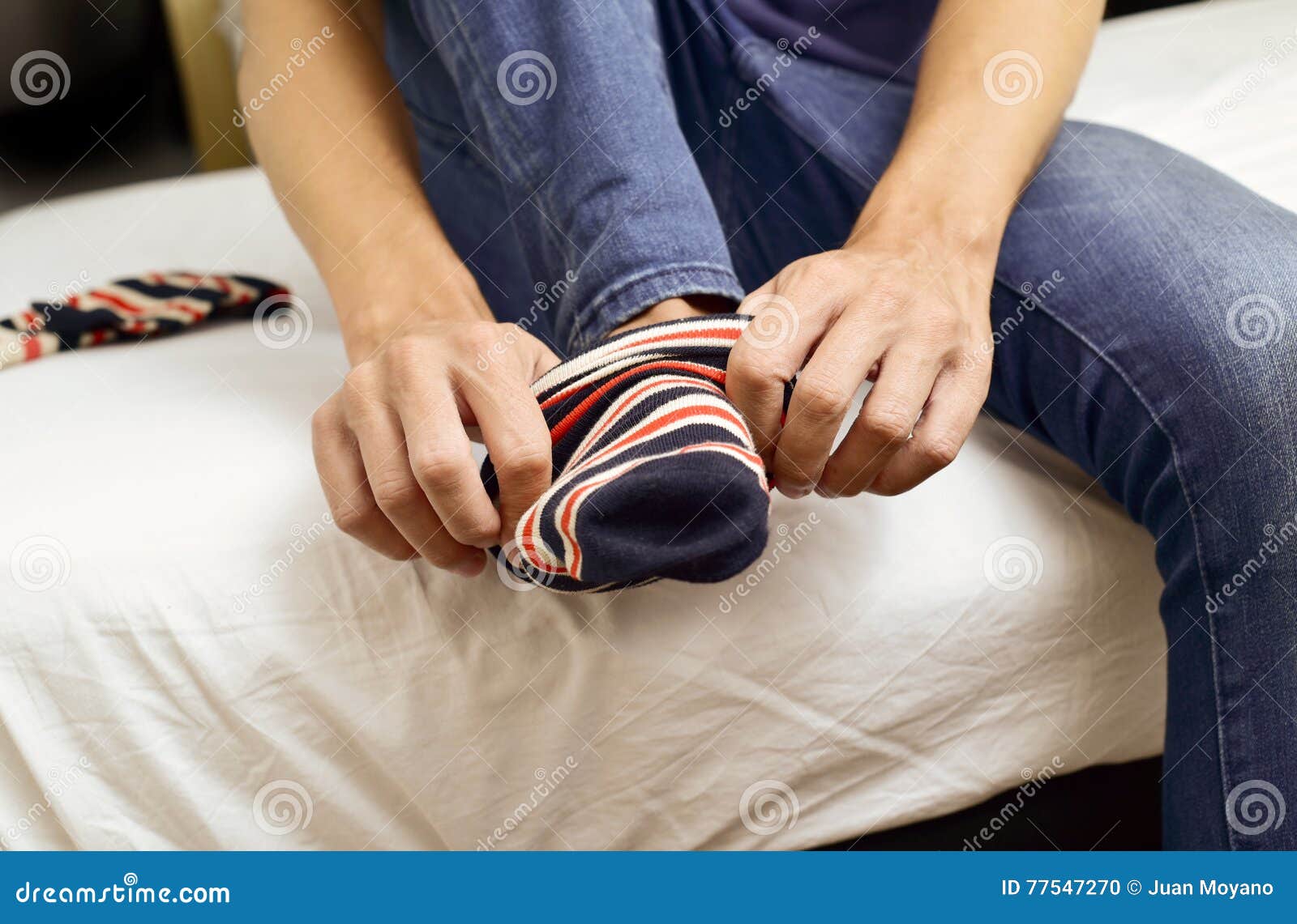 young-man-putting-on-or-taking-off-his-socks-stock-photo-image-of