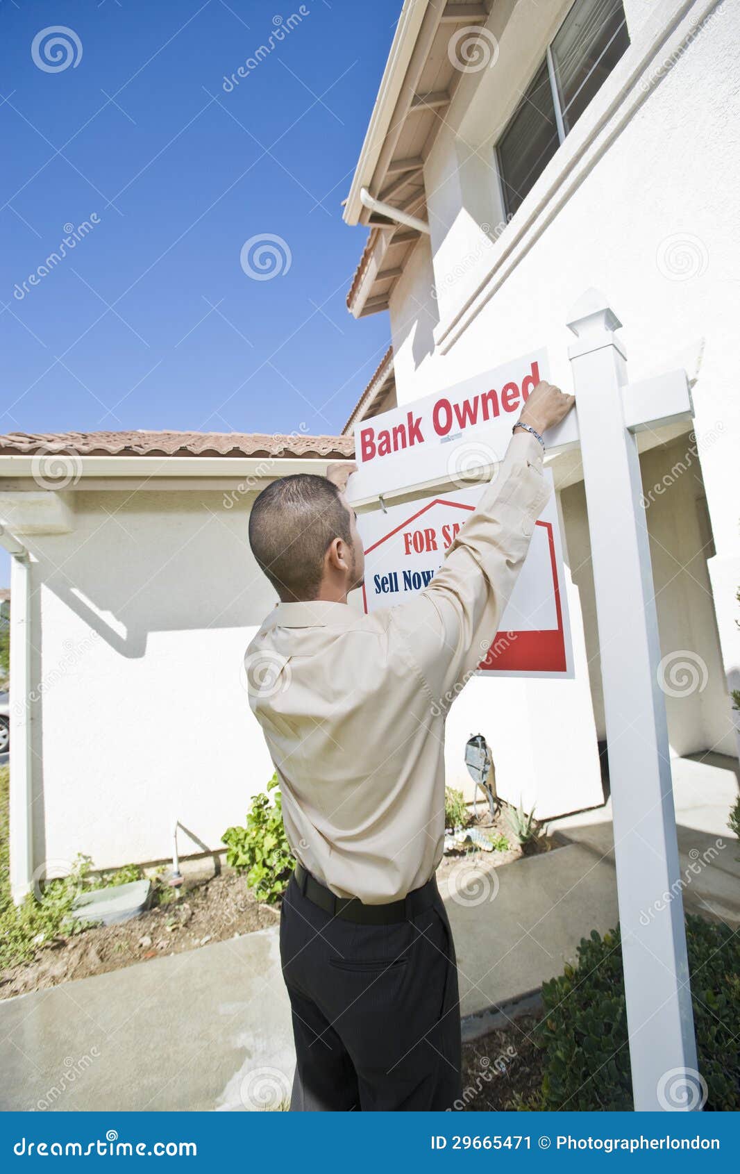 Young Man Putting Up For Sale Notice