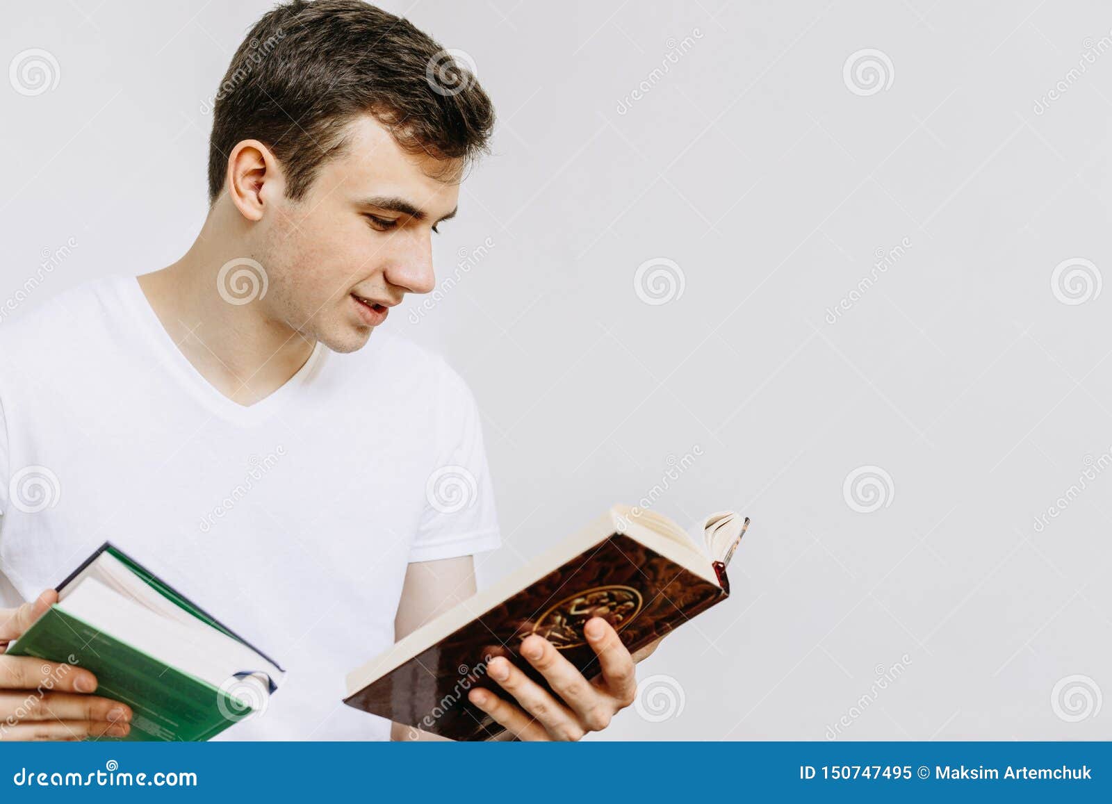 A Young Man Is Reading A Book. Selects A Book In The Store