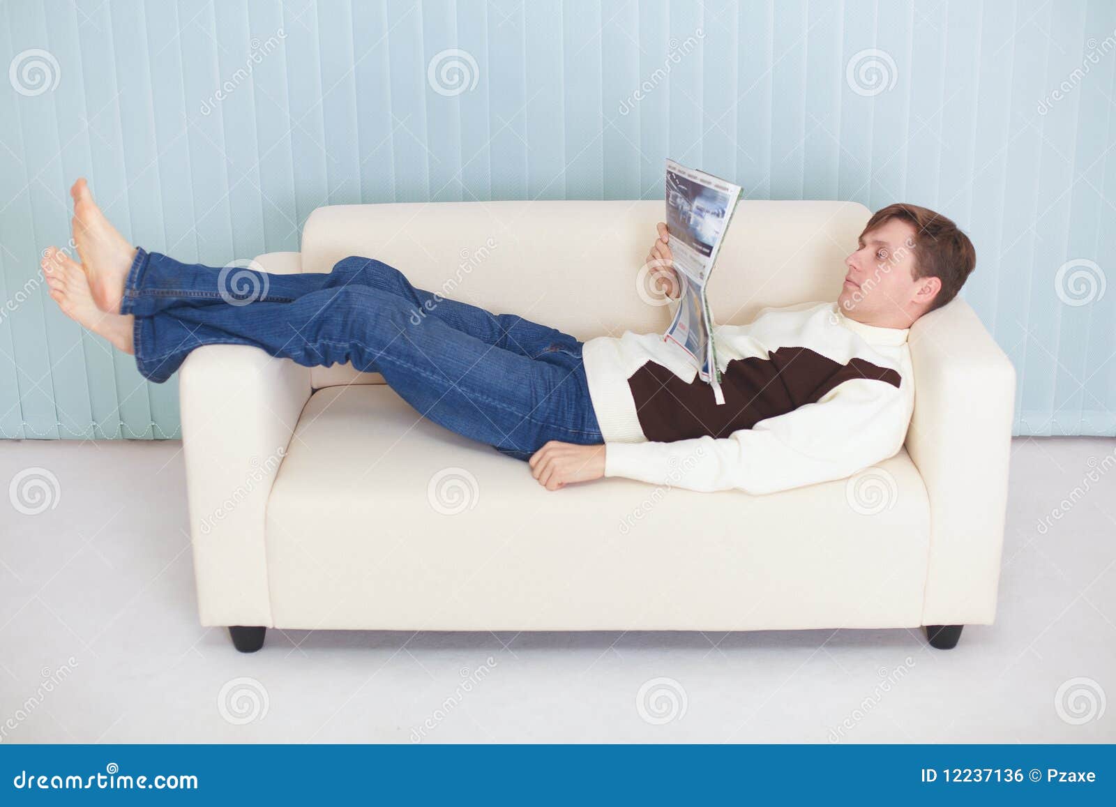 Young Man Reads Magazine Lying on Couch Stock Photo Image of journal