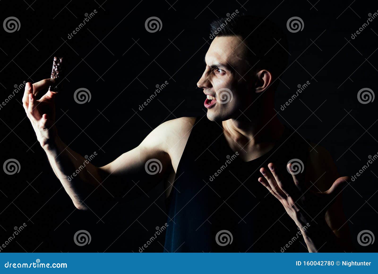 A Young Man Refuses Chocolate and Sugar in the Gym Stock Photo Image