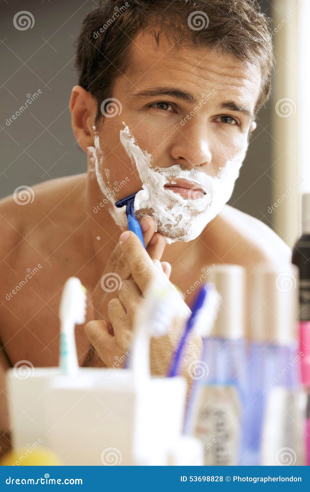 Young man shaving stock photo. Image of head, bathroom 53698828